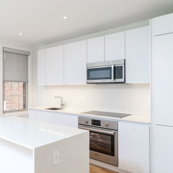 updated kitchen with stainless steel appliances and granite countertops