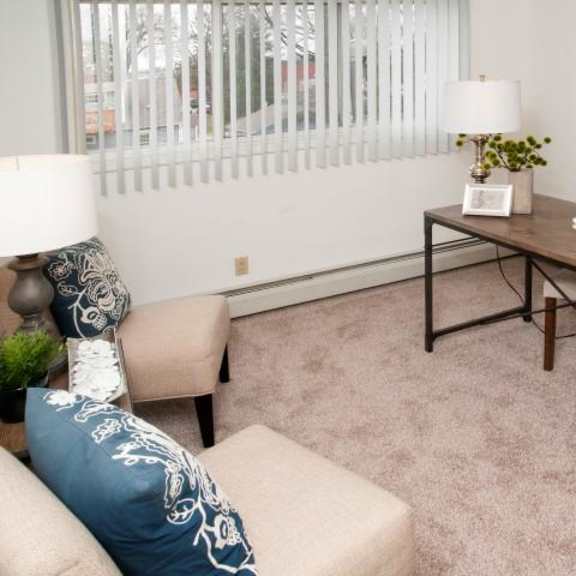 second bedroom office space with light walls and beige carpet at 8920 wentwoth apartment in bloomington, mn