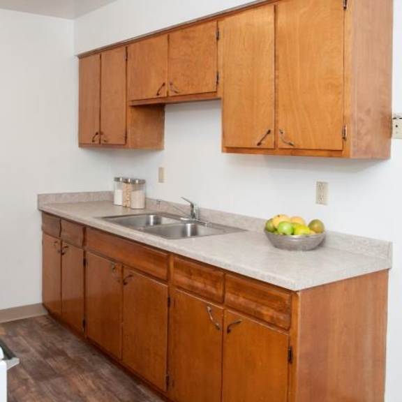 8920 wentworth apartment kitchen with wooden cabinetry and white appliances