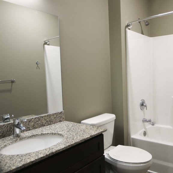 Thumbnail 9 of 19 Spacious bathroom with tub shower and granite countertops in 2 bedroom apartment for rent at North Pointe Villas best new apartments Lincoln NE 68521