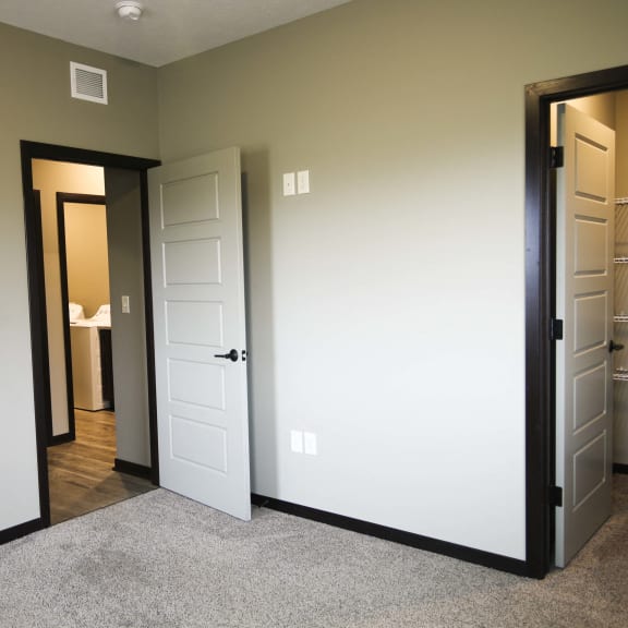 Thumbnail 12 of 19 Bedroom with attached walk in closet at North Pointe Villas