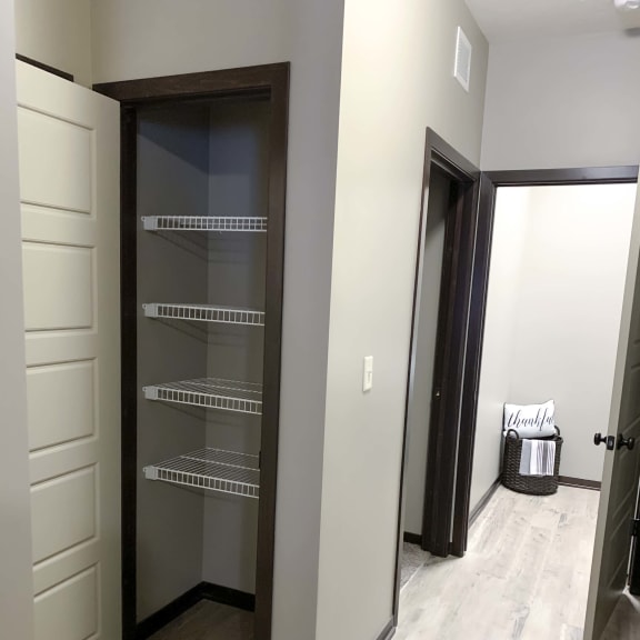 Thumbnail 10 of 19 Hallway linen closet and laundry room in the Harper three bedroom floor plan