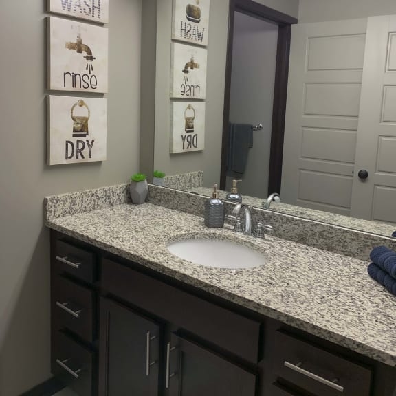 Thumbnail 12 of 19 Large vanity with granite counter tops in the full bath in the Harper three bedroom floor plan