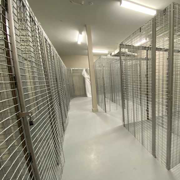 a room with large floor-to-ceiling storage lockers for residents at the flats at tioga town center.