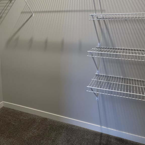 Thumbnail 12 of 21 Empty wire shelving in a room.