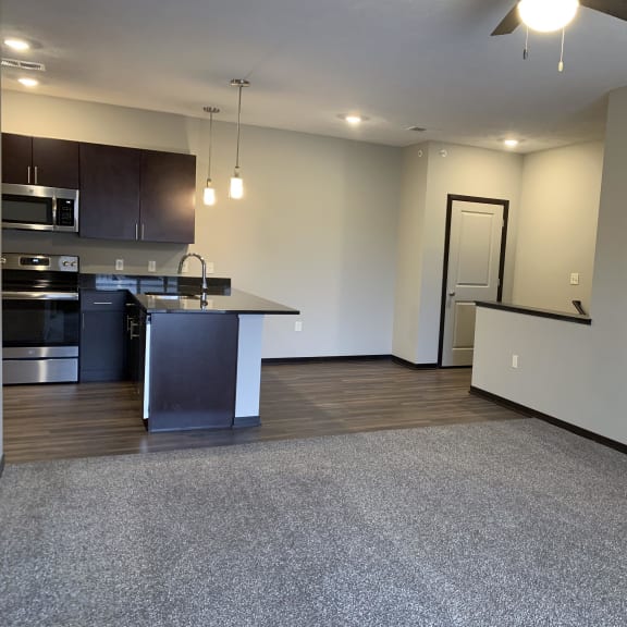 Thumbnail 20 of 21 A spacious kitchen with dark wood cabinets and stainless steel appliances.