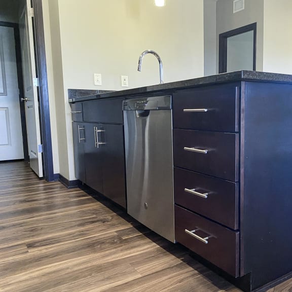 Thumbnail 19 of 23 A kitchen island with a dishwasher underneath it.