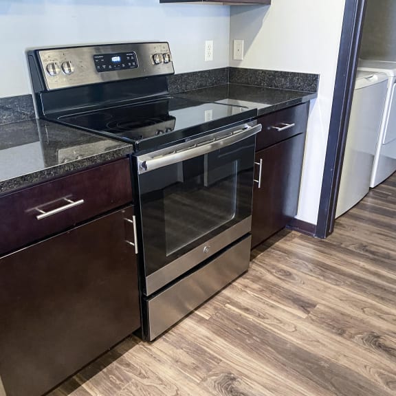 Thumbnail 20 of 23 A black stove top oven with a glass door is on a counter.