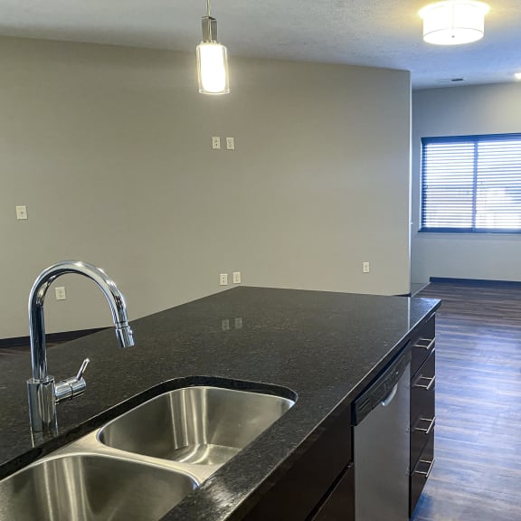 Thumbnail 22 of 23 A kitchen with a sink and a window.