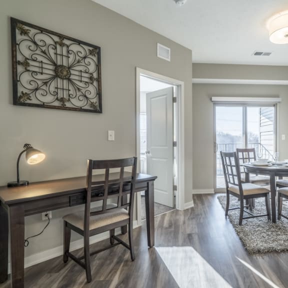 Thumbnail 5 of 23 A dining room with a table and chairs.