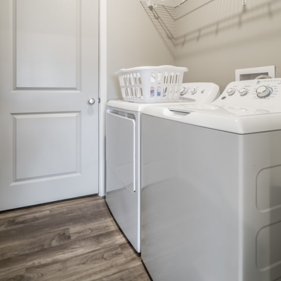 Thumbnail 13 of 23 A white door is next to a white washing machine.