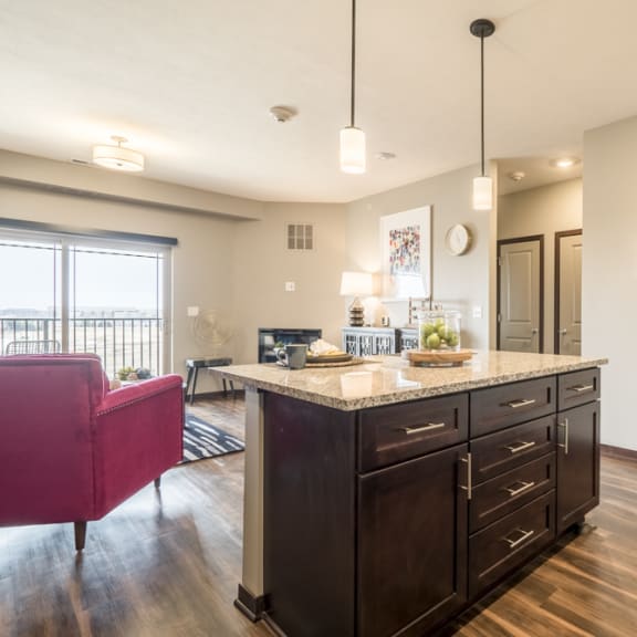Thumbnail 7 of 13 View of kitchen island and living room at 360 at Jordan West
