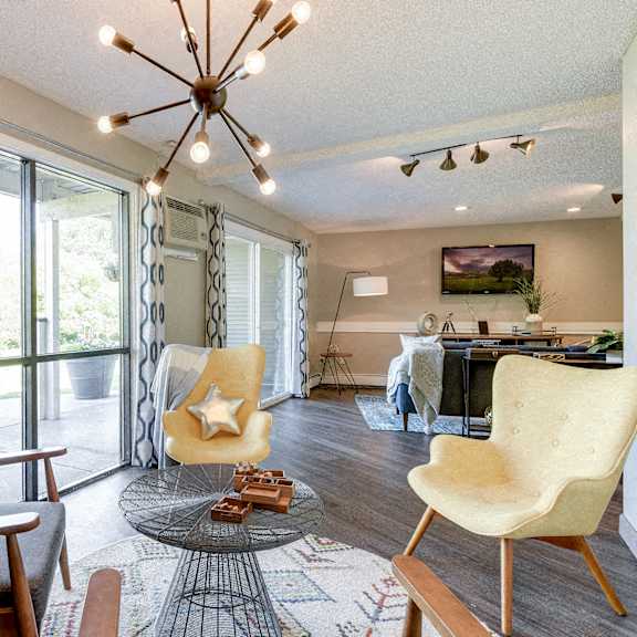 community room with a large window and a chandelier at pheasant park apartments, minnesota