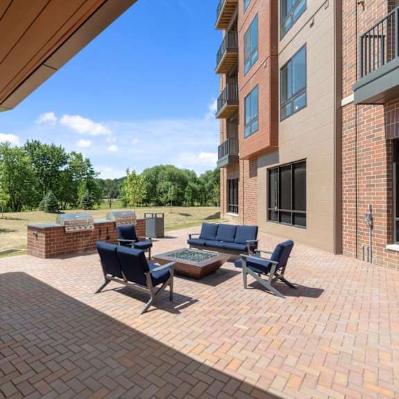 an outdoor fire pit lounge with comfortable seating near a barbecue grilling station and shaded patio  at keva flats, exton, pennsylvania