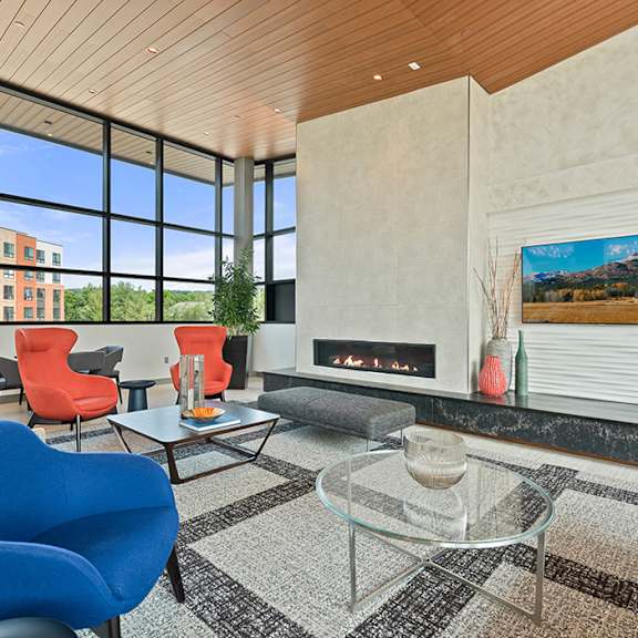 a private conference room with flexible work spaces, a modern fireplace, large windows, and comfortable seating lounges. at keva flats, exton, 19341