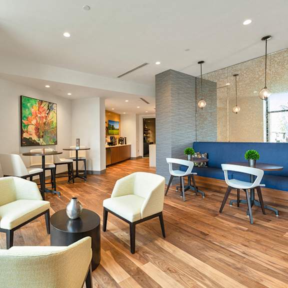 a resident lounge with several tables, chairs, and a complimentary coffee bar. at keva flats, pennsylvania