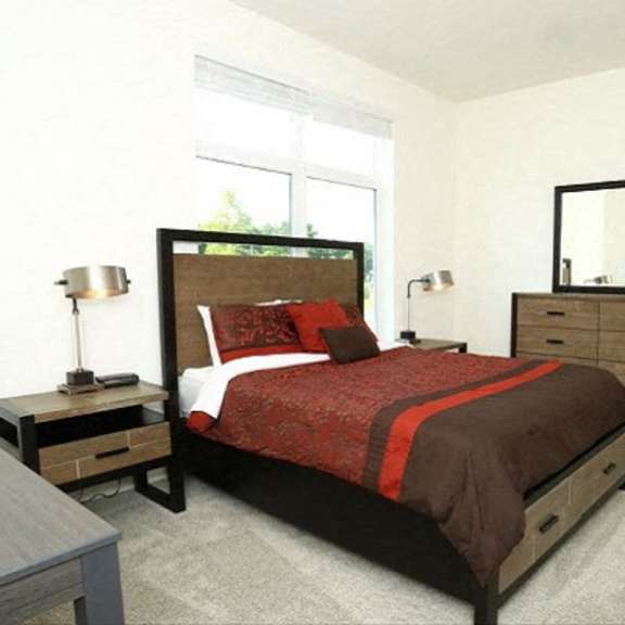 bedroom with a cozy bed  at brooks apartments, midland, mi, 48642