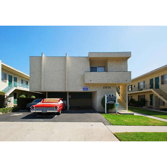 a red car parked in front of a building