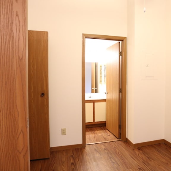 image of master bedroom with vinyl plank flooring and bathroom