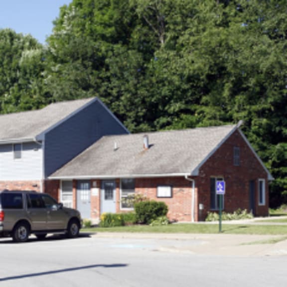 a car is parked in front of a house.