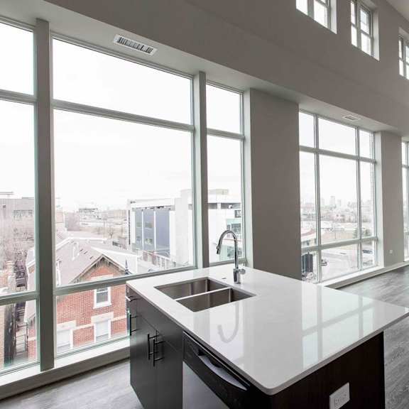a kitchen with a large island and a view of the city.