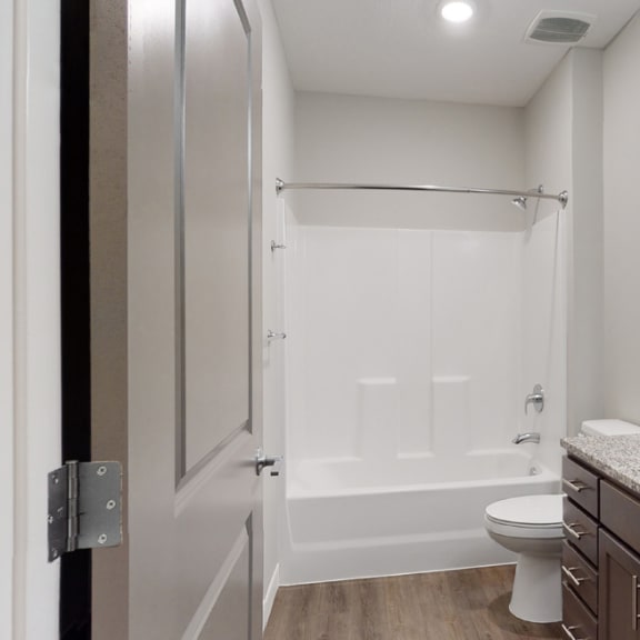 Thumbnail 15 of 28 The 2 bedroom Hibiscus floor plan features a spacious bathroom with granite vanity top and a tub/shower.