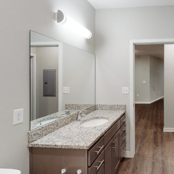 Thumbnail 16 of 28 The 2 bedroom Hibiscus floor plan features a spacious bathroom with granite vanity top and a tub/shower.