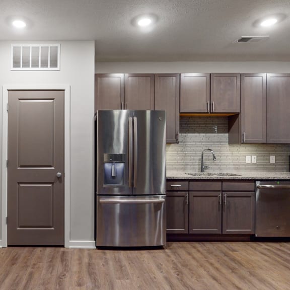 Thumbnail 4 of 28 This 2 bedroom Hibiscus floor plan features an open kitchen with neutral gray cabinets, light granite countertops, and a large pantry.
