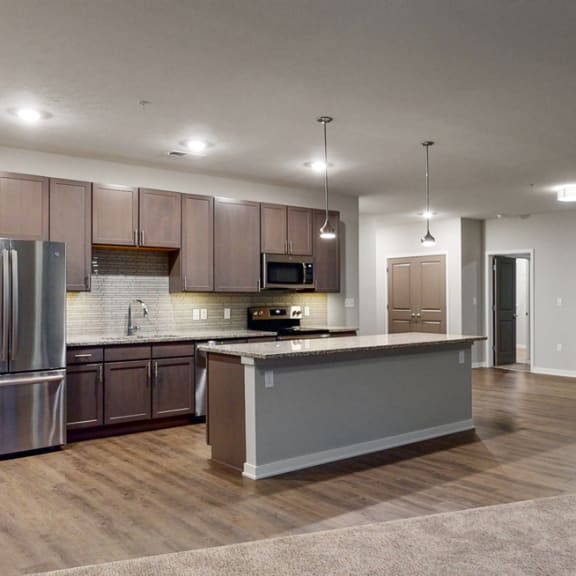 Thumbnail 3 of 28 The 2 bedroom Hibiscus floor plan at WH Flats features an open spacious kitchen area with granite countertops and large island.