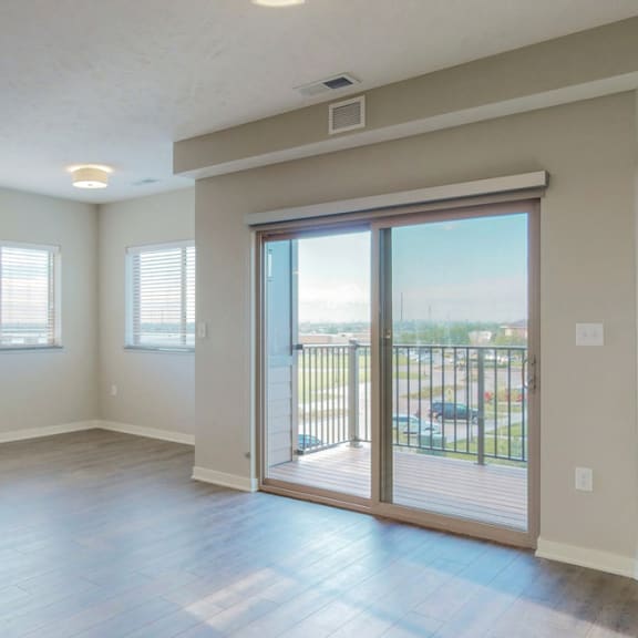 Thumbnail 6 of 19 The 2 bedroom Marigold with den floor plan at WH Flats features natural light and a spacious living and dining area.
