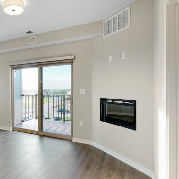 Thumbnail 8 of 19 The 2 bedroom Marigold with den floor plan at WH Flats features natural light and a spacious dining and living area with electric fireplace.