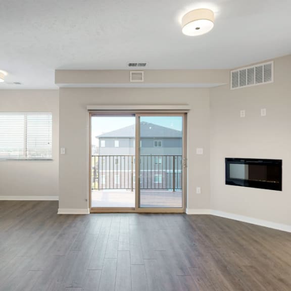 Thumbnail 9 of 19 The 2 bedroom Marigold with den floor plan at WH Flats features natural light and a spacious dining and living area with electric fireplace.
