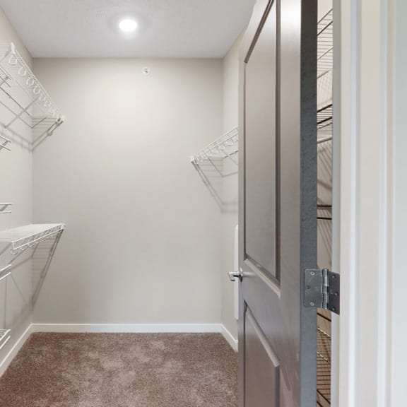 Thumbnail 18 of 19 You'll love the large walk-in closet in the master bedroom of the Marigold with den floor plan at WH Flats.