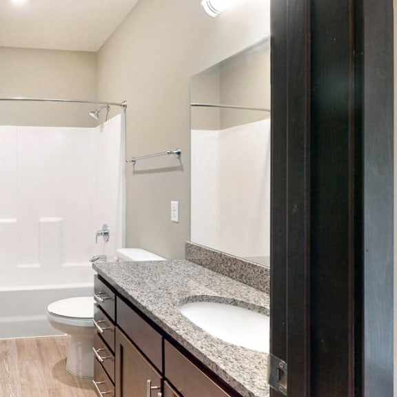 Thumbnail 6 of 24 The 2 bedroom Snowdrop with den floor plan features a spacious bathroom with granite vanity top and a tub/shower.