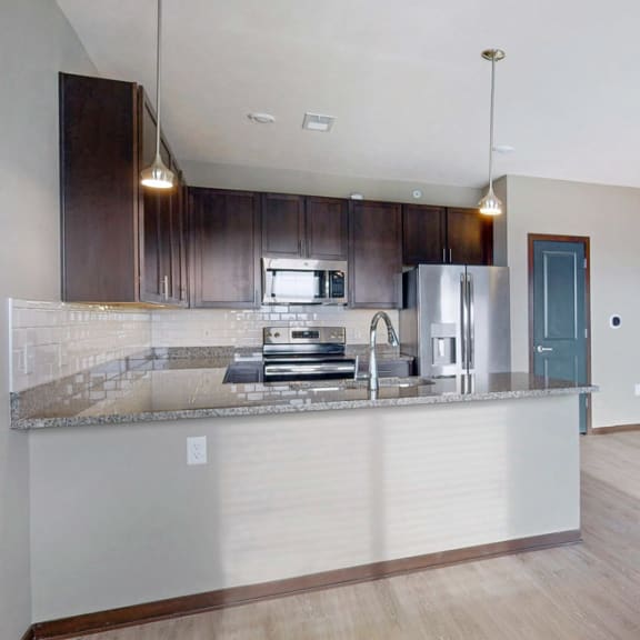 Thumbnail 5 of 24 The 2 bedroom Snowdrop with den floor plan at WH Flats features natural light and a spacious living and dining area.