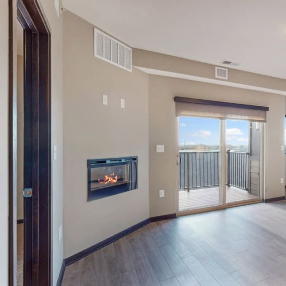 Thumbnail 16 of 24 The 2 bedroom Snowdrop with den floor plan at WH Flats features natural light and a spacious dining and living area with electric fireplace.