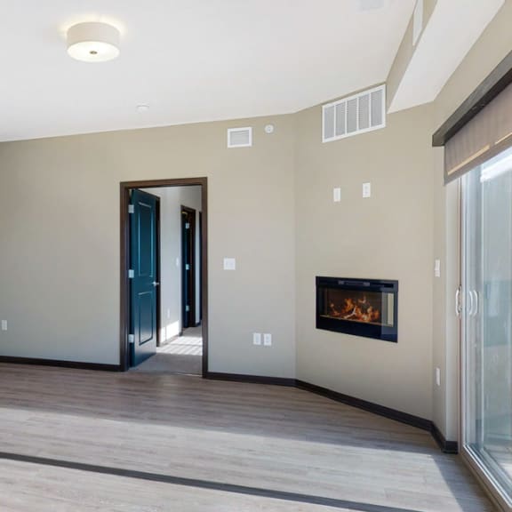 Thumbnail 18 of 24 The 2 bedroom Snowdrop with den floor plan at WH Flats features natural light and a spacious dining and living area with electric fireplace.