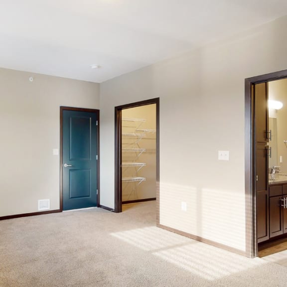 Thumbnail 21 of 24 You'll love the large walk-in closet in the master bedroom of the Snowdrop with den floor plan at WH Flats.