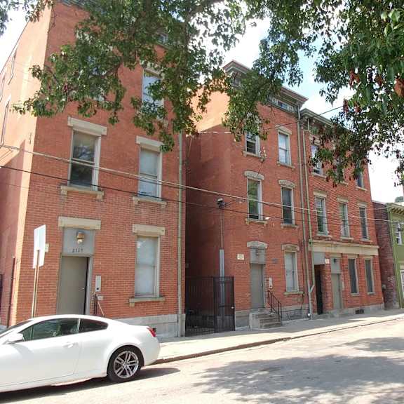 exterior of brick apartment building from across the street