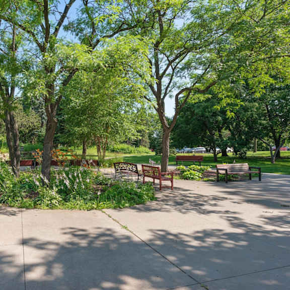 a park with benches and trees at humboldt senior 55+ apartments, saint paul, mn