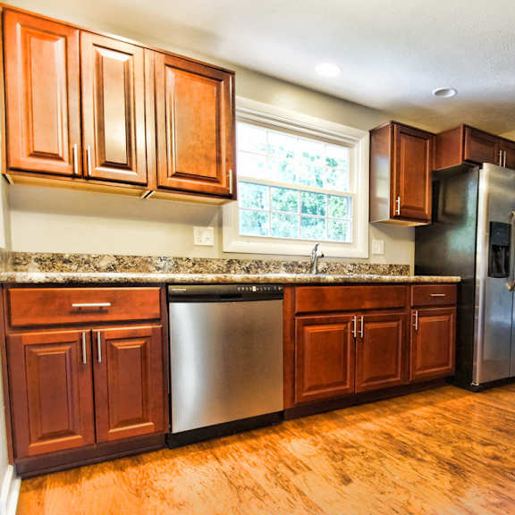 a kitchen with wooden cabinets and stainless steel appliances..
