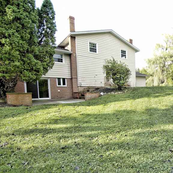 a house with a green back yard.
