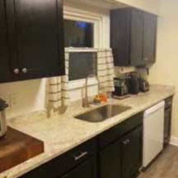 kitchen with dark cabinets and granite counters