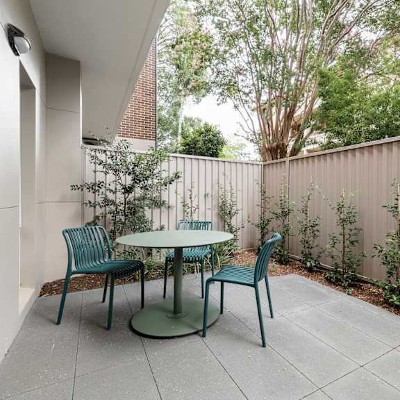 a patio with a table and chairs.