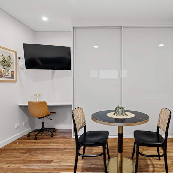 a modern dining room with a round table and chairs.