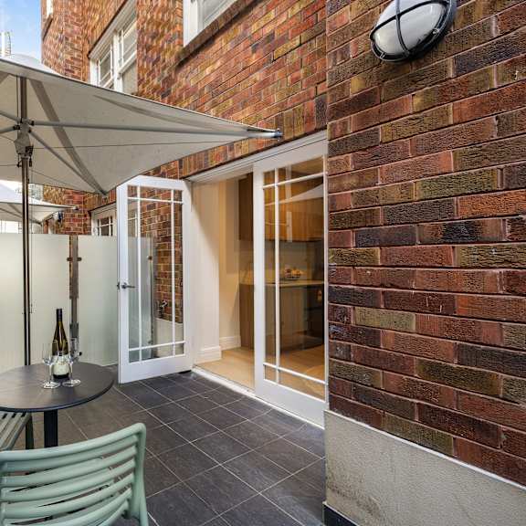 a patio with a table and chairs under a canopy.