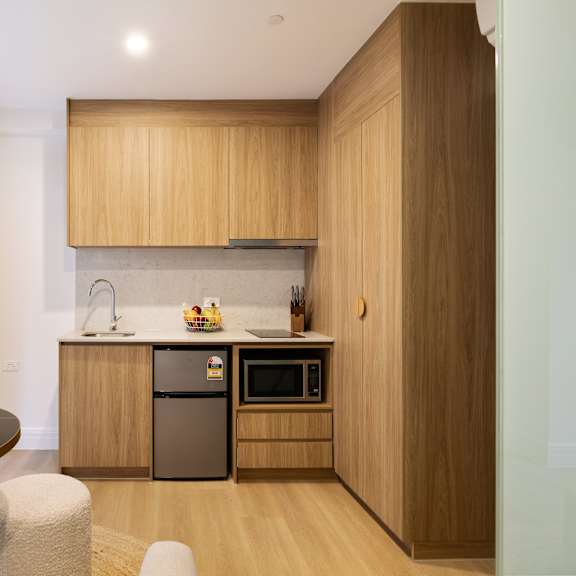 a modern kitchen with wooden cabinets and a black countertop.