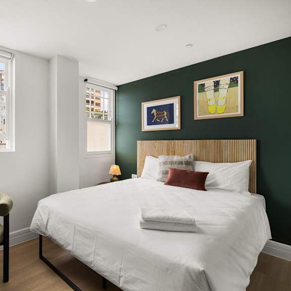 a bedroom with a large bed and a table with chairs.