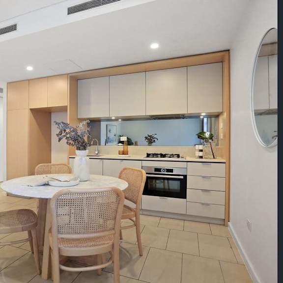a kitchen and dining area with a table and chairs