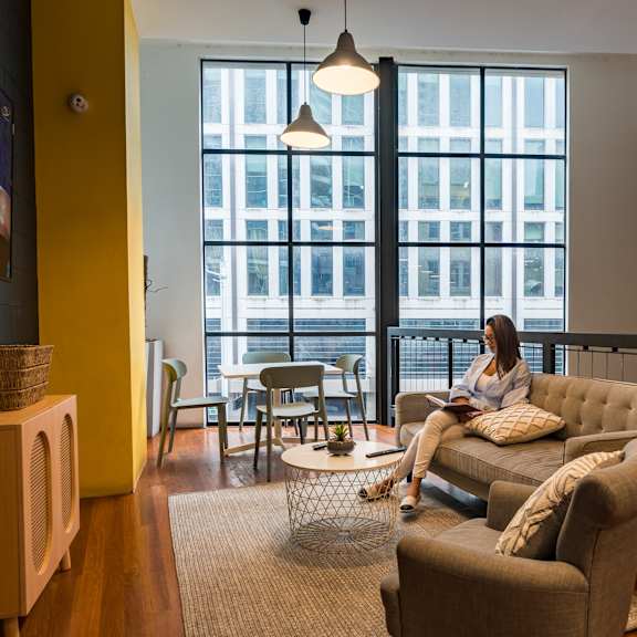 a woman sitting on a couch in a living room